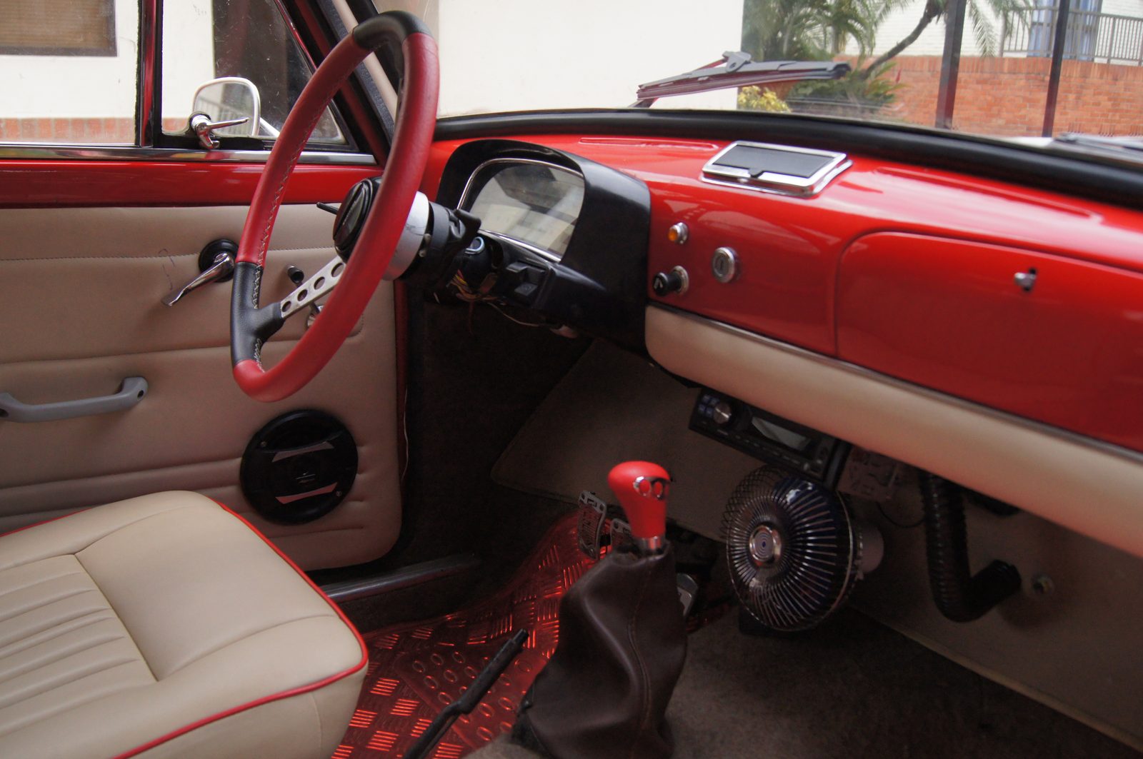 Interior — volante deportivo rojo y tablero restaurado